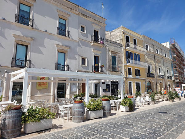 Restaurants line Brindisi Harbor, Italy