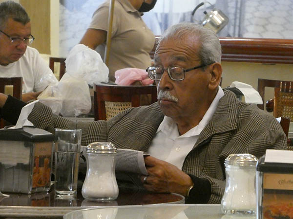 Gentleman reading newspaper at Cafe del Portal, Veracruz, Mexico
