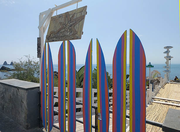 Colorful display of painted surfboards on eastern coast of Sicily