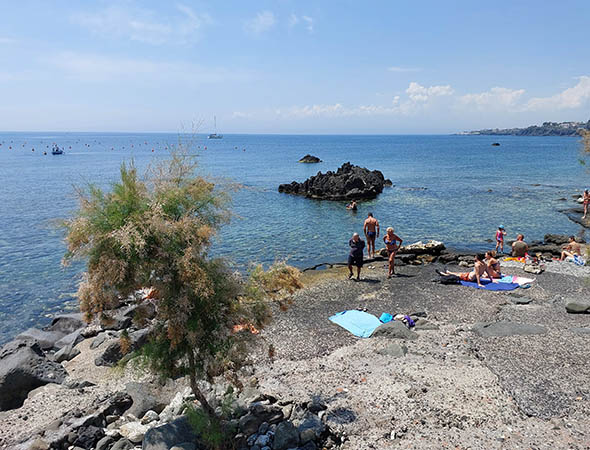 Sunbathers on eastern coast of Sicily