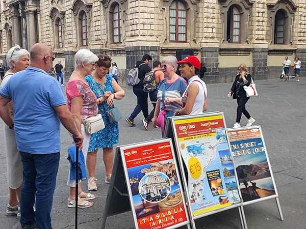 people waiting around for the tour bus to arrive, Catania, Sicily