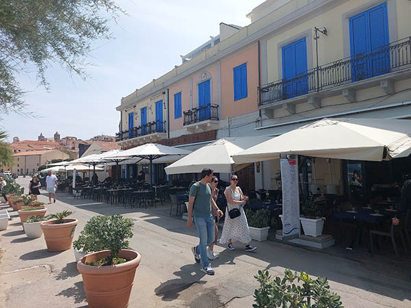 Pastel buildings with bright blue doors, Cefalu, Sicily