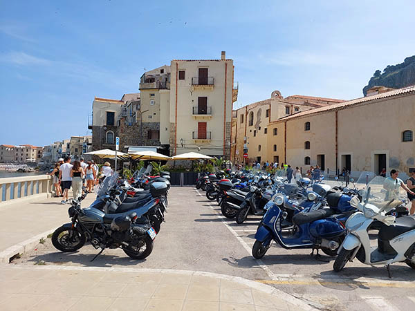 Motorcycles for rent all lined up, Cefalu Beach, Cefalu, Sicily