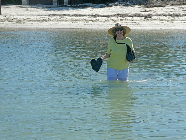 Akaisha wading into ocean to get to sandbars, Holbox, Yucatan, Mexico