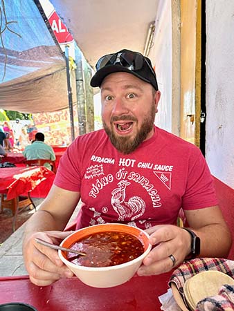 Peter trying new foods at the Sunday market in Playa del Carmen, Mexico