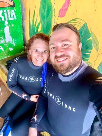 Man and woman in scuba suits