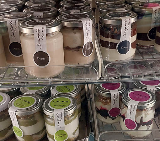 Tiramisu and various desserts in a jar at bakery in Lecce, Italy