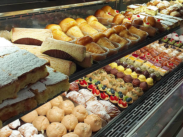 Rum Baba and various desserts at bakery in Lecce, Italy