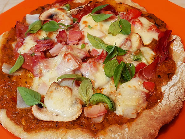 Our Biga dough pizza with home made pizza sauce, meats, Provolone cheese, mushrooms and fresh basil from our garden