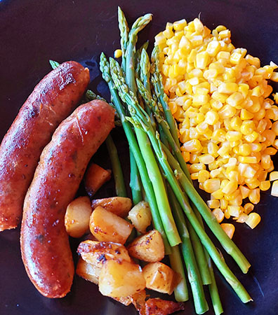 Hot Italian sausage, roasted potatoes, grilled asparagus and fresh corn off the cob