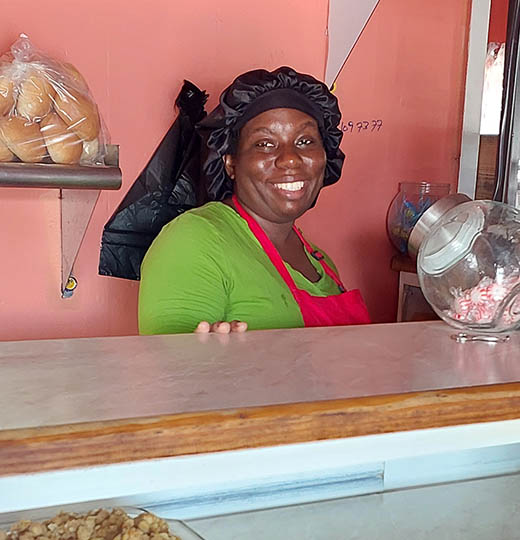 Black woman behind bakery counter, Nevis, West Indies 