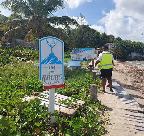 Walking along the wooden plank that lines the beach to On The Rocks, Nevis, West Indies