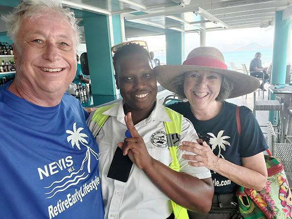 Senior couple with immigration officer at On The Rocks Bar and Lounge, Nevis, West Indies