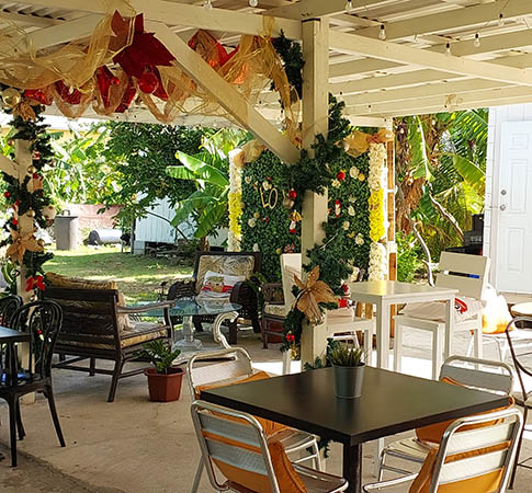 outdoor seating with garden view at Rosie's Pattys, Nevis, West Indies
