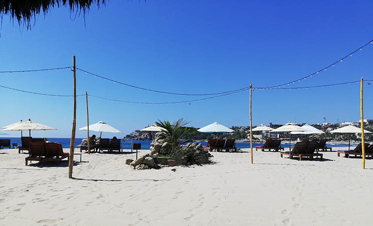 Beach chairs and umbrellas on Playa Principal, Puerto Escondido, Mexico