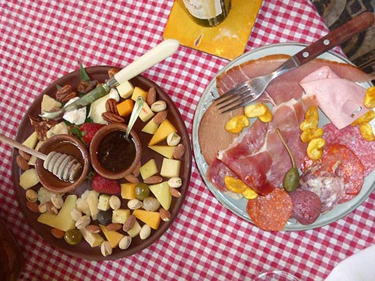 Nuts, fruit, olives, a selection of cheeses and a variety of cured cut meats