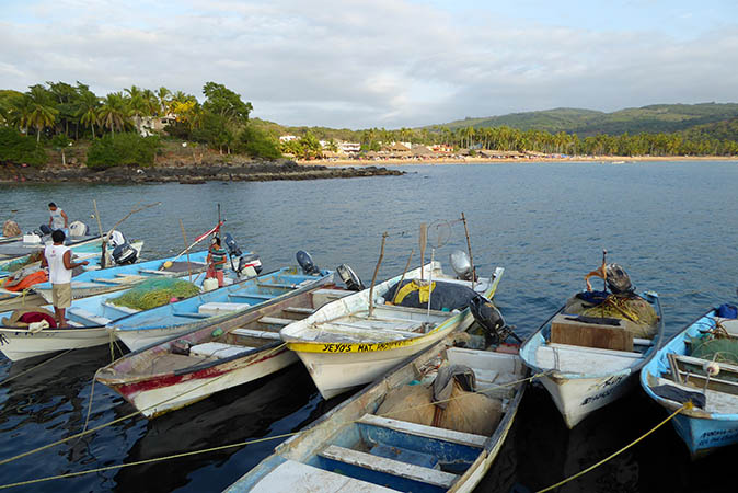 Fishermen standing in their boats at day's end