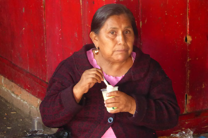 Purepecha woman eating her yogurt