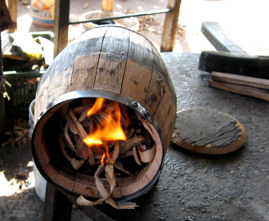 Charring a barrel used for aging tequila, Jalisco, Mexico