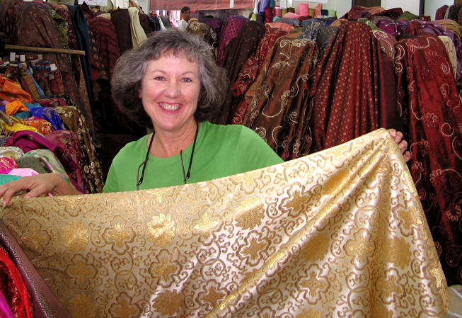 Akaisha choosing an array of Chinese silk in Chiangmai, Thailand
