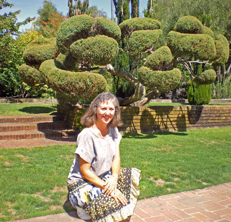 Akaisha in front of sculptured tree. Filoli garden, Woodside, California