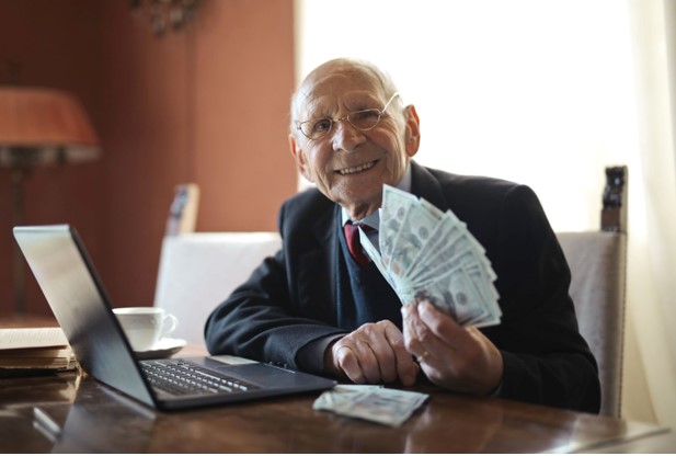 Happy Seniior businessman holding money in his hand